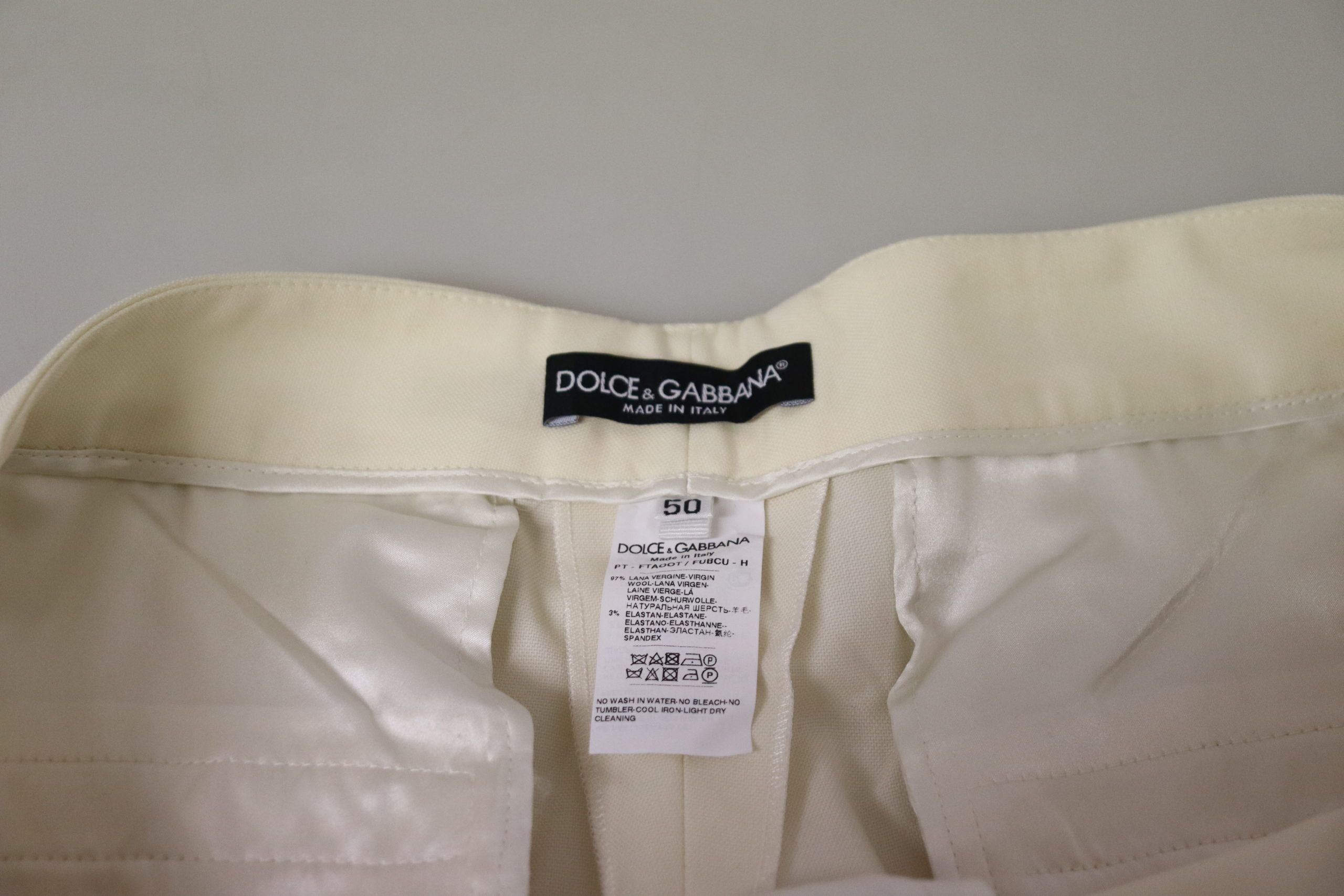 Ivory high waist cropped trousers with folded hem by Dolce & Gabbana, showcasing a stylish and tailored fit.