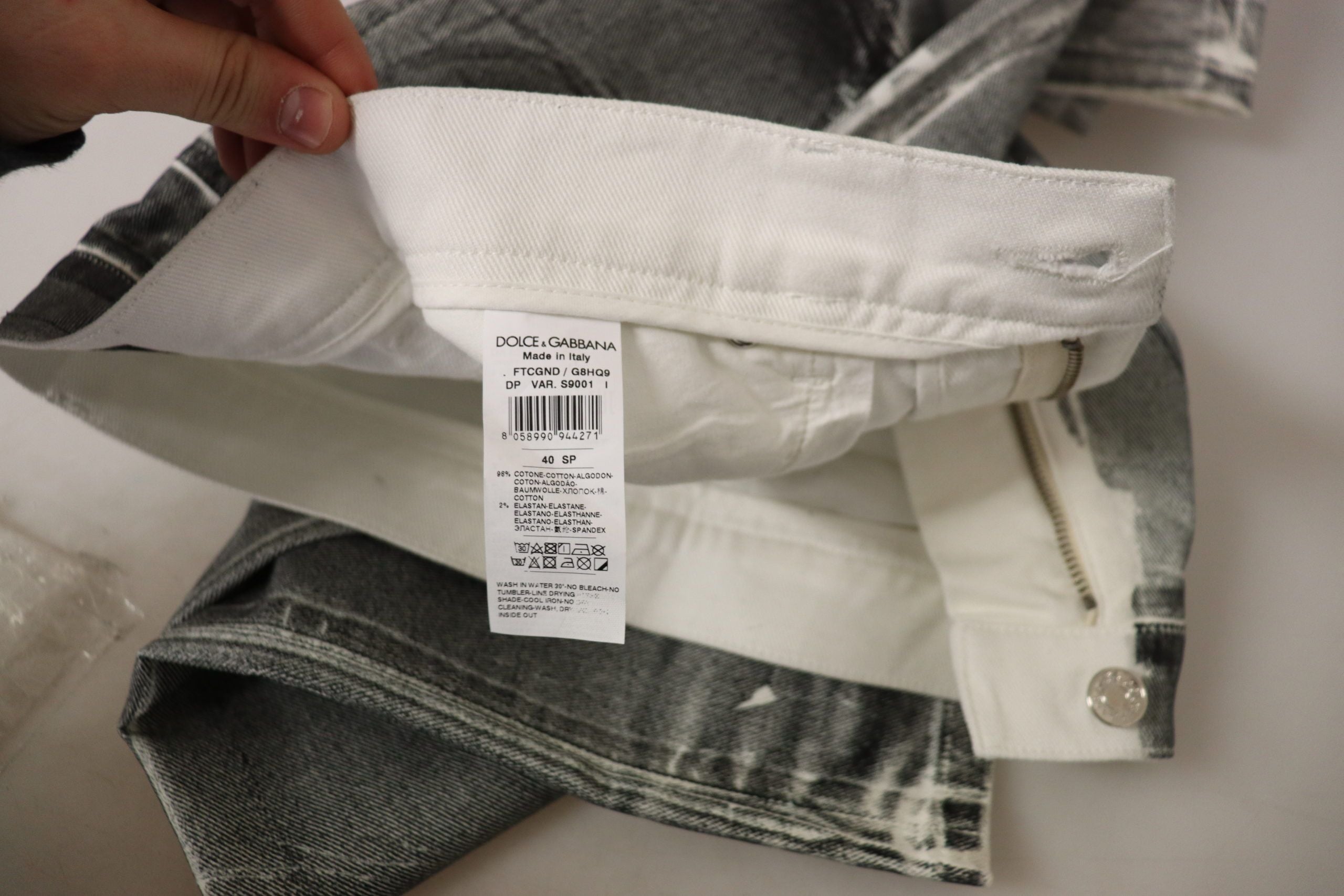 Grey washed high waist denim jeans by Dolce & Gabbana, cotton fabric, classic five-pocket style, shown on a model.