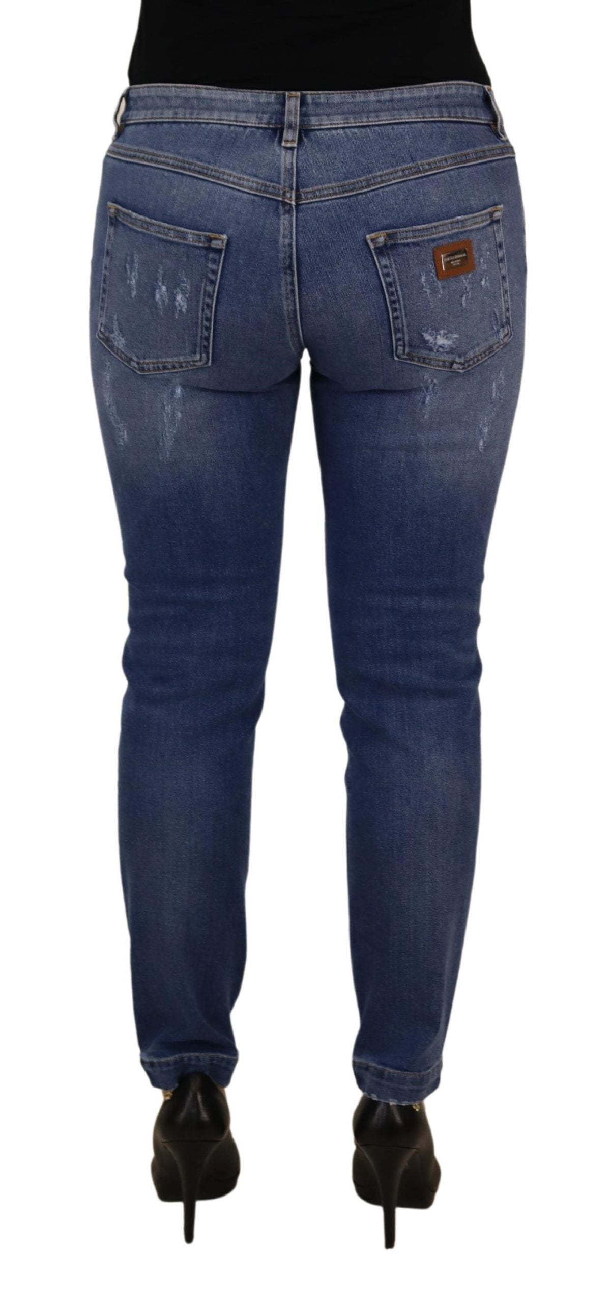 Blue washed cotton skinny low waist denim jeans by Dolce & Gabbana, shown on a hanger against a neutral background.