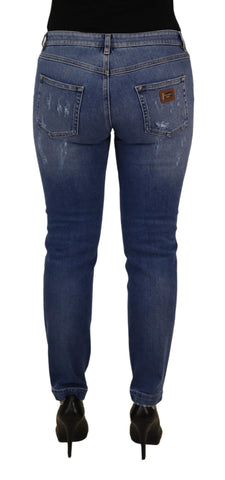 Blue washed cotton skinny low waist denim jeans by Dolce & Gabbana, shown on a hanger against a neutral background.