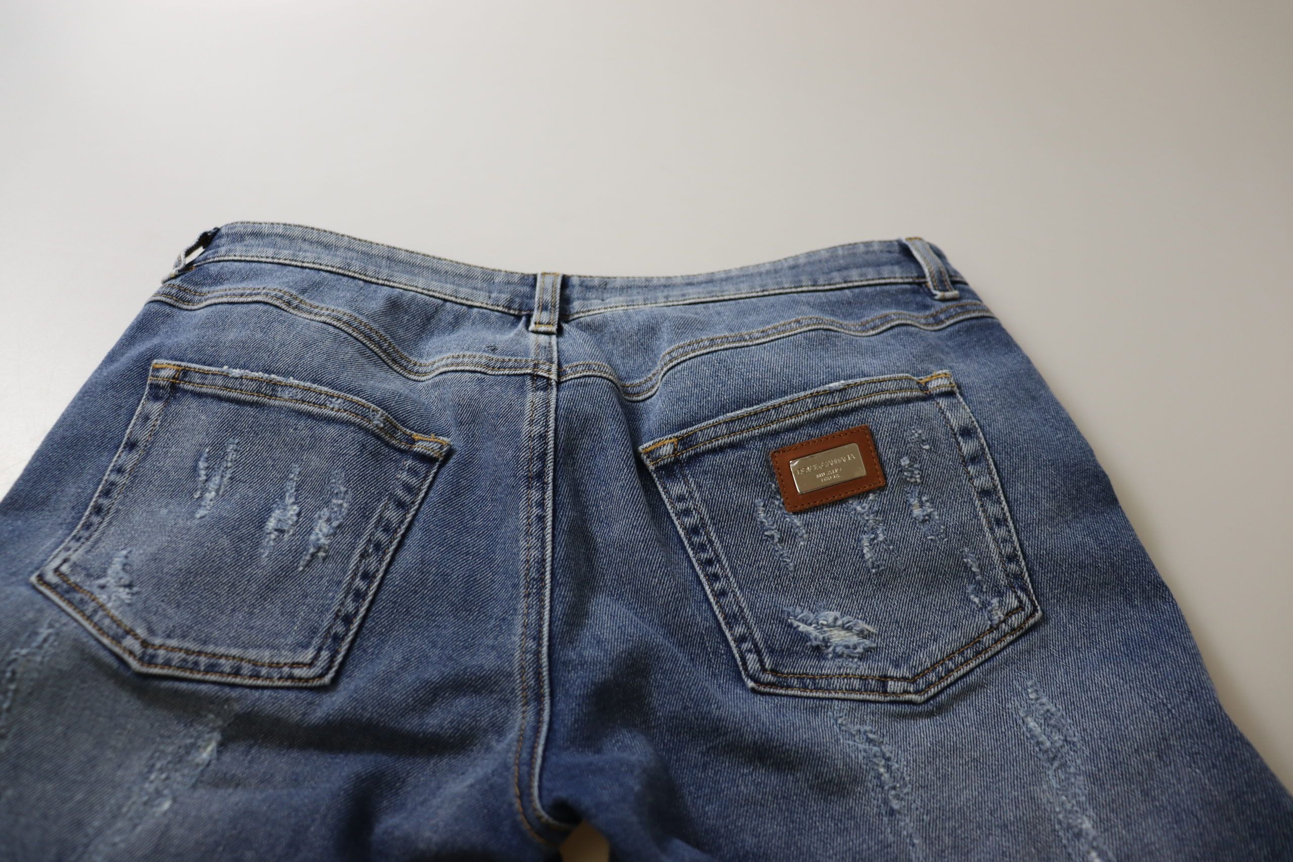 Blue washed cotton skinny low waist denim jeans by Dolce & Gabbana displayed on a hanger.