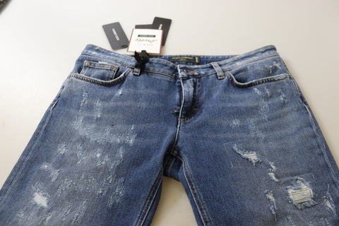 Blue washed cotton skinny low waist denim jeans by Dolce & Gabbana displayed on a hanger.