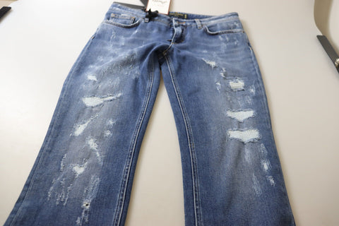 Blue washed cotton skinny low waist denim jeans by Dolce & Gabbana, shown on a model, with visible stitching and classic five-pocket design.