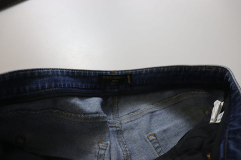 Blue washed cotton skinny low waist denim jeans by Dolce & Gabbana displayed on a hanger