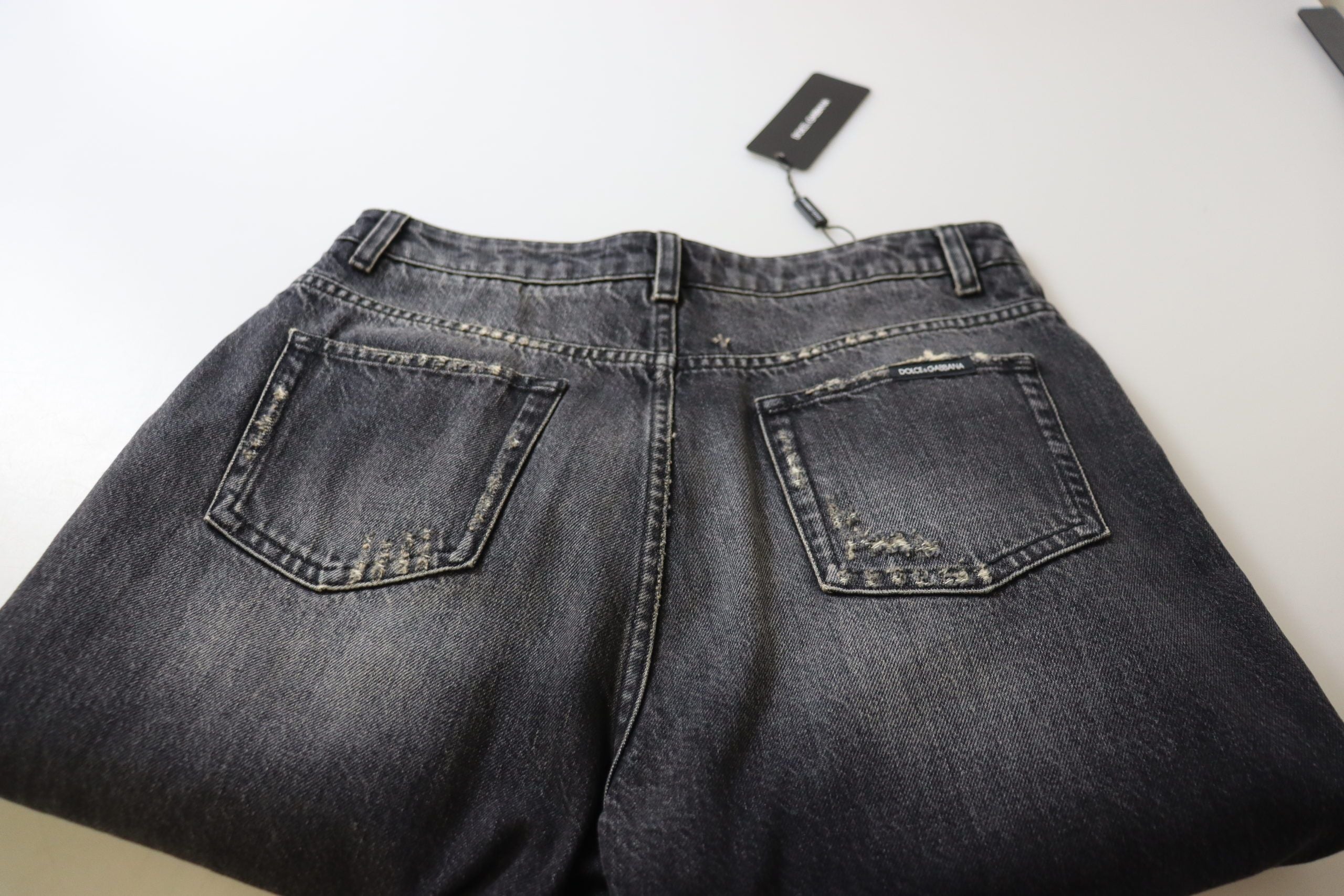 Black washed tattered high waist denim jeans from Dolce & Gabbana, featuring distressed details and a classic high-rise fit.