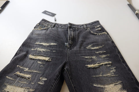 Black washed tattered high waist denim jeans by Dolce & Gabbana, featuring distressed details and a fitted high-rise style.