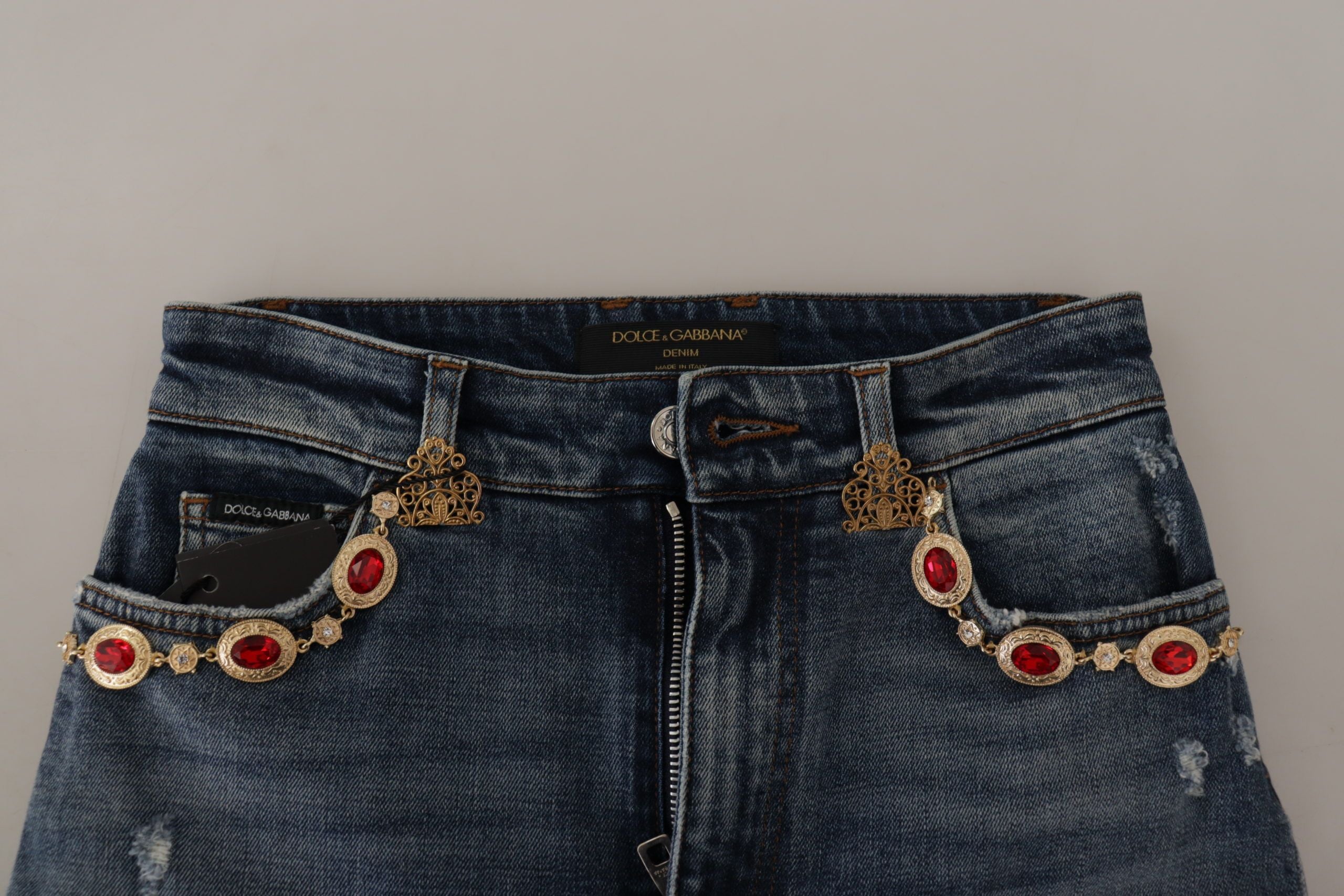 Blue denim jeans with crystal embellishments, stylish Dolce & Gabbana pants showcasing intricate detailing and a modern fit.