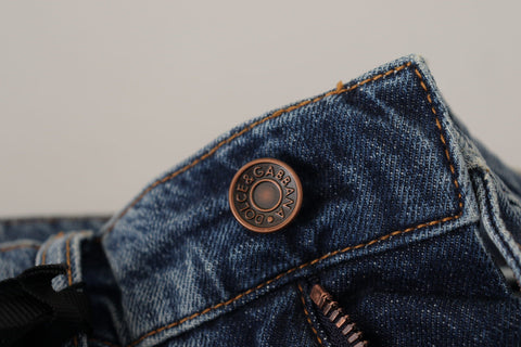 Blue denim jeans with Baroque heart logo patch from Dolce & Gabbana, showing detailed embroidery and classic jean styling.