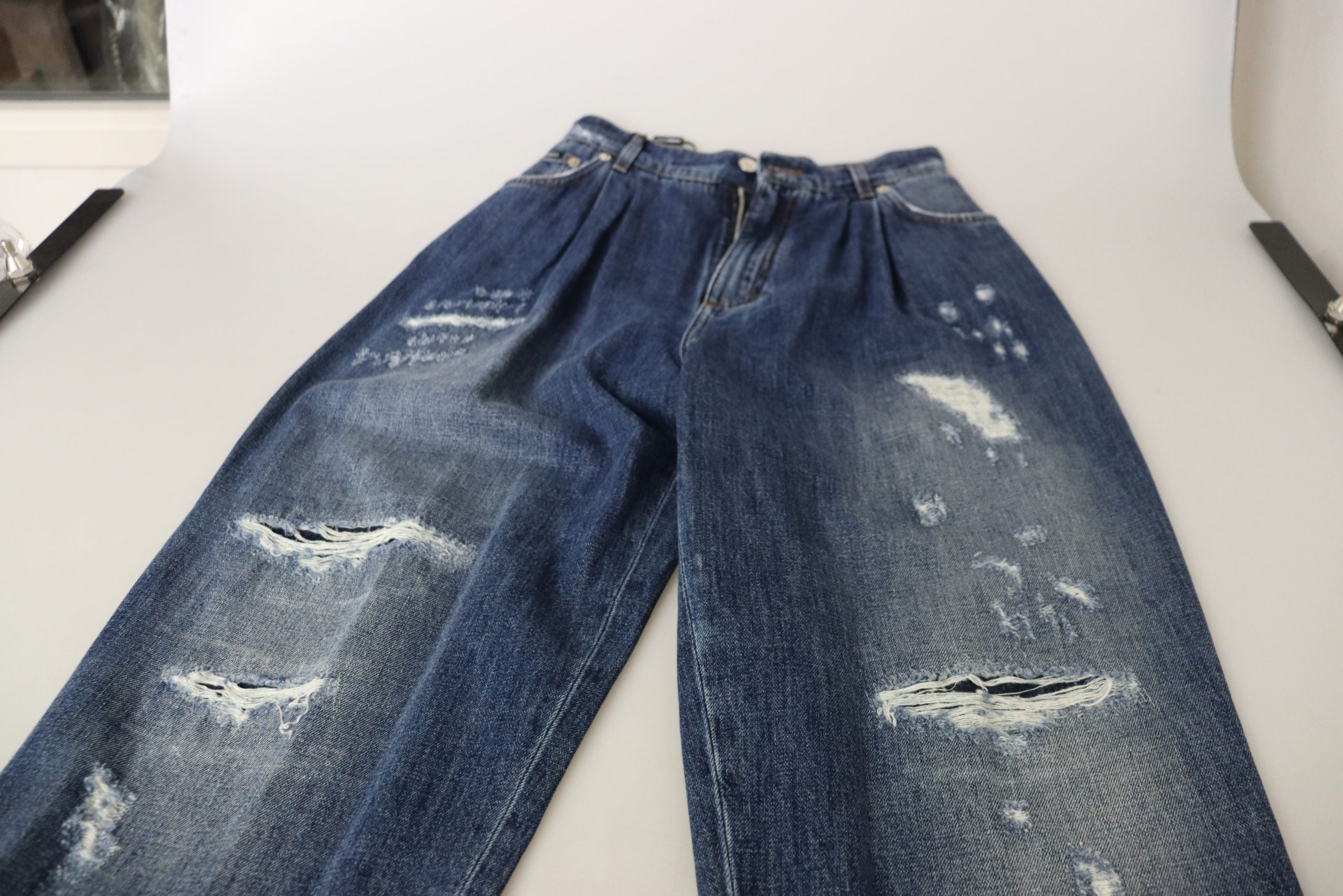 Blue washed high waist loose fit pants by Dolce & Gabbana, displayed on a hanger with a relaxed fit and casual style.