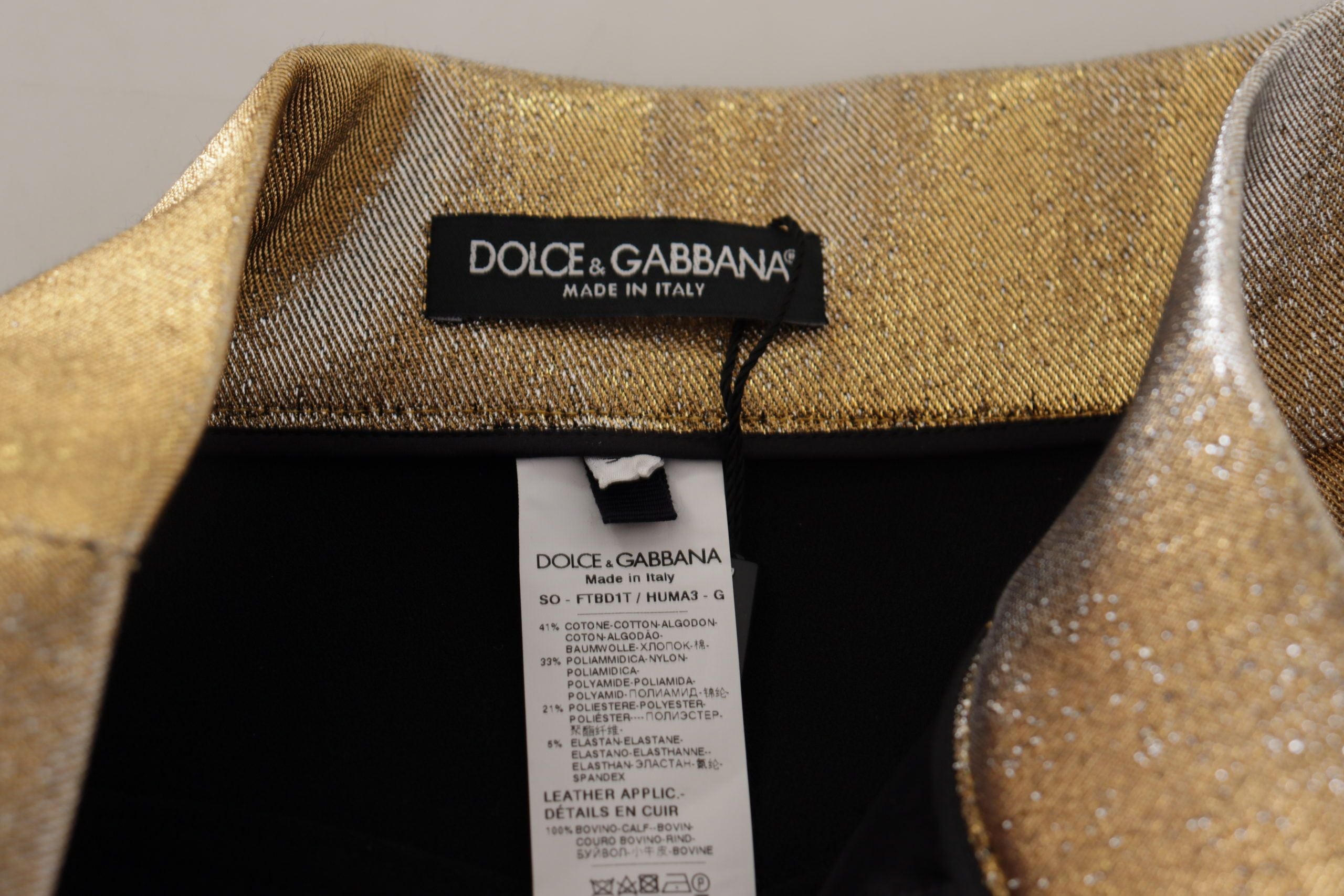 Gold cotton blend glittered hot shorts by Dolce & Gabbana, featuring a shiny, stylish design perfect for fashionable summer wear.