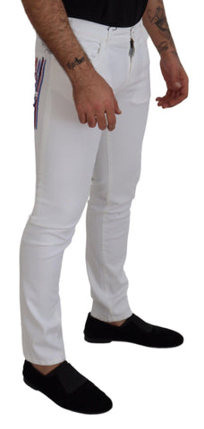 White slim skinny stretch cotton denim jeans by Dolce & Gabbana, showing close-up of fitted, stylish jeans fabric and design details.