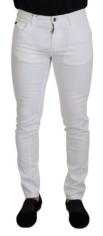 White slim skinny stretch cotton denim jeans by Dolce & Gabbana, showing a close-up of the fitted waist and leg details.