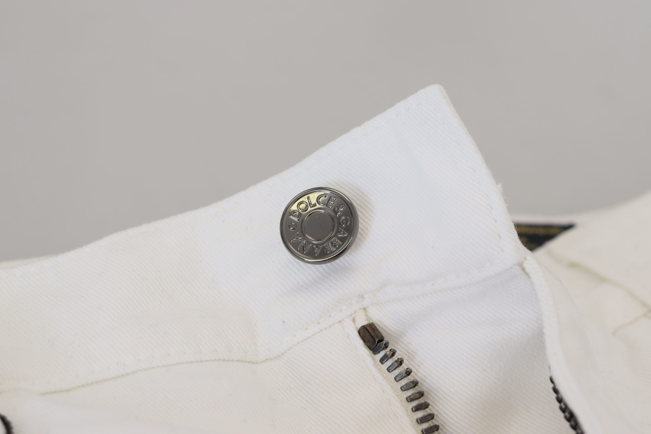 White slim skinny stretch cotton denim jeans by Dolce & Gabbana, showing fitted design and classic five-pocket style.