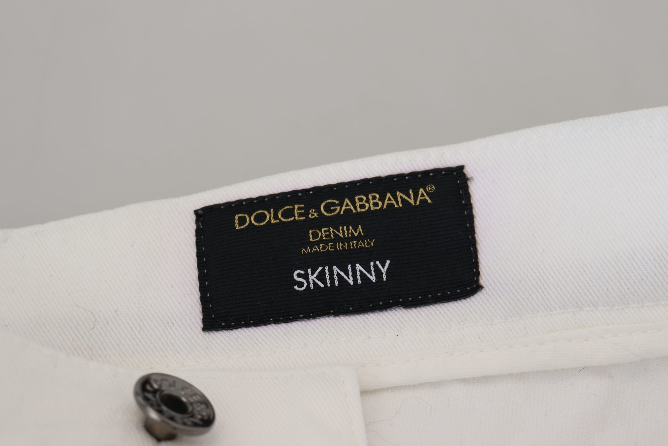 White slim skinny stretch cotton denim jeans by Dolce & Gabbana, shown front view with classic five-pocket design.
