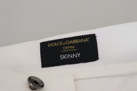 White slim skinny stretch cotton denim jeans by Dolce & Gabbana, shown front view with classic five-pocket design.