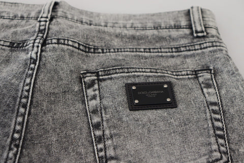 Gray slim fit stretch cotton denim jeans by Dolce & Gabbana displayed on a hanger with front and back views.
