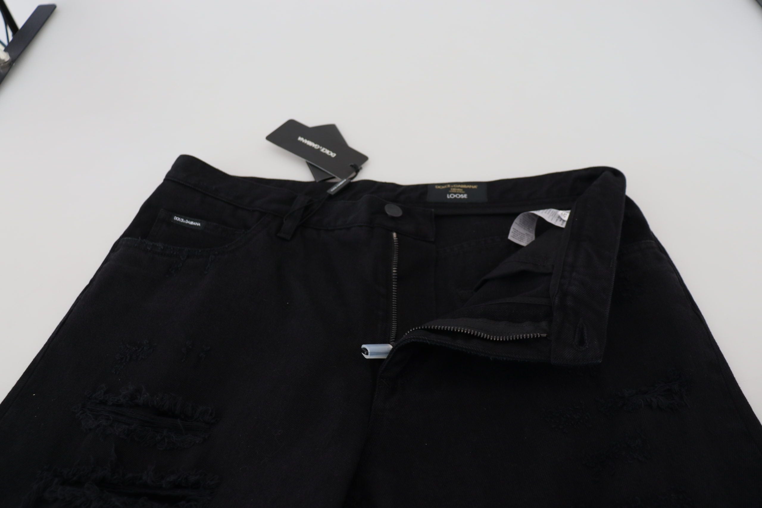 Black loose regular fit torn cotton jeans by Dolce & Gabbana showing distressed details and relaxed style.