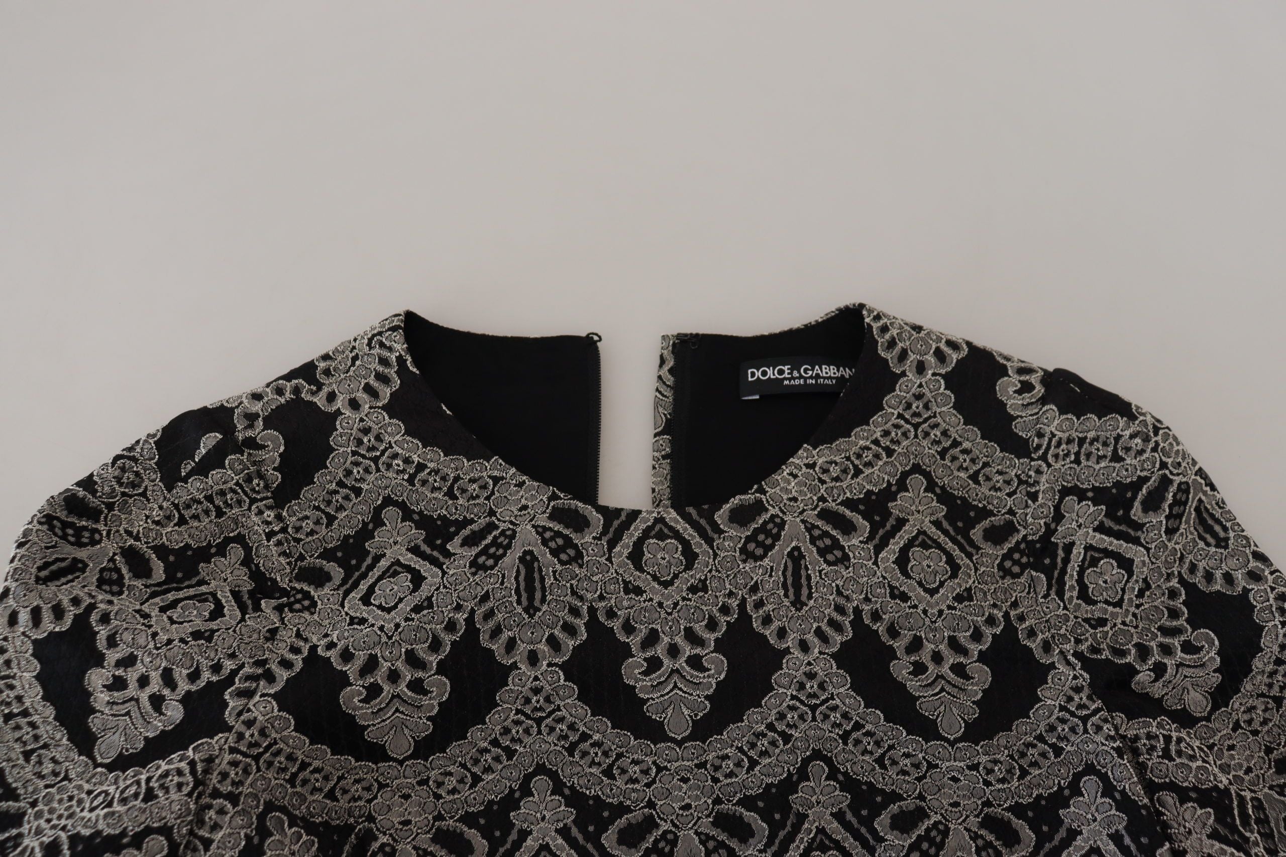 Black and gray jacquard sheath bodycon dress by Dolce & Gabbana, featuring a fitted silhouette and intricate pattern.