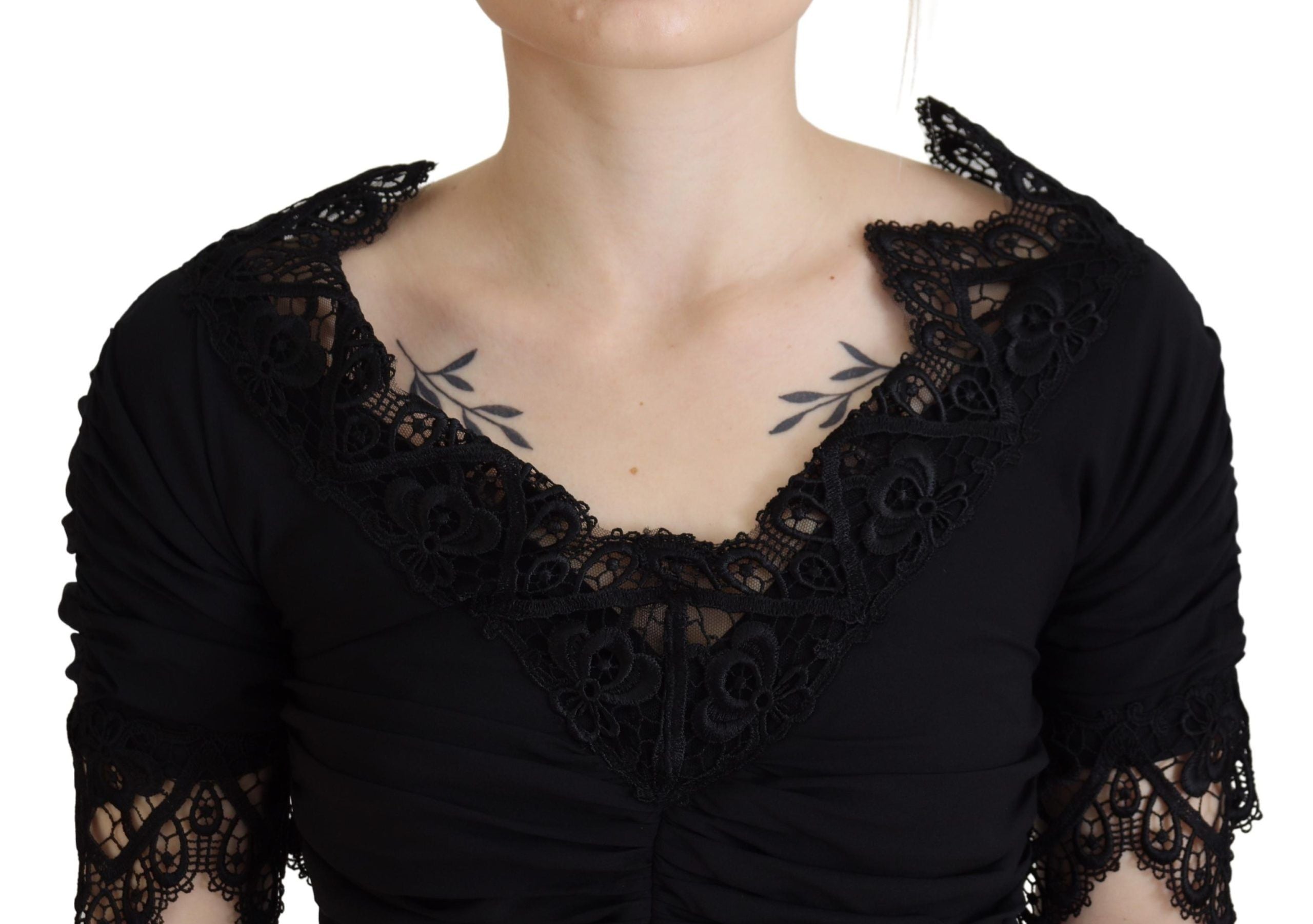 Black sheath midi bodycon dress with lace and silk fabric by Dolce & Gabbana, close-up showing fitted silhouette and intricate details.