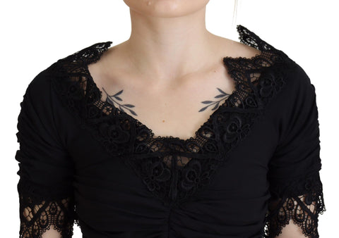Black sheath midi bodycon dress with lace and silk fabric by Dolce & Gabbana, close-up showing fitted silhouette and intricate details.