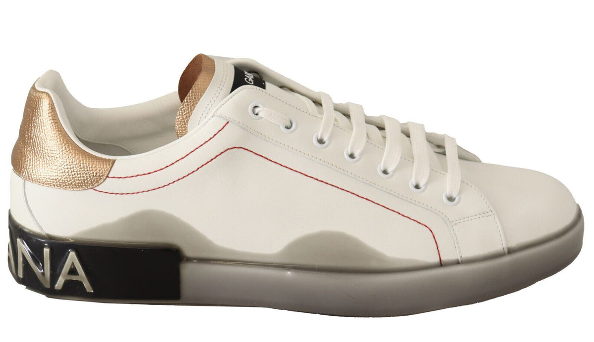 White gold leather low top sneakers by Dolce & Gabbana featuring casual design and white laces on a clean background.