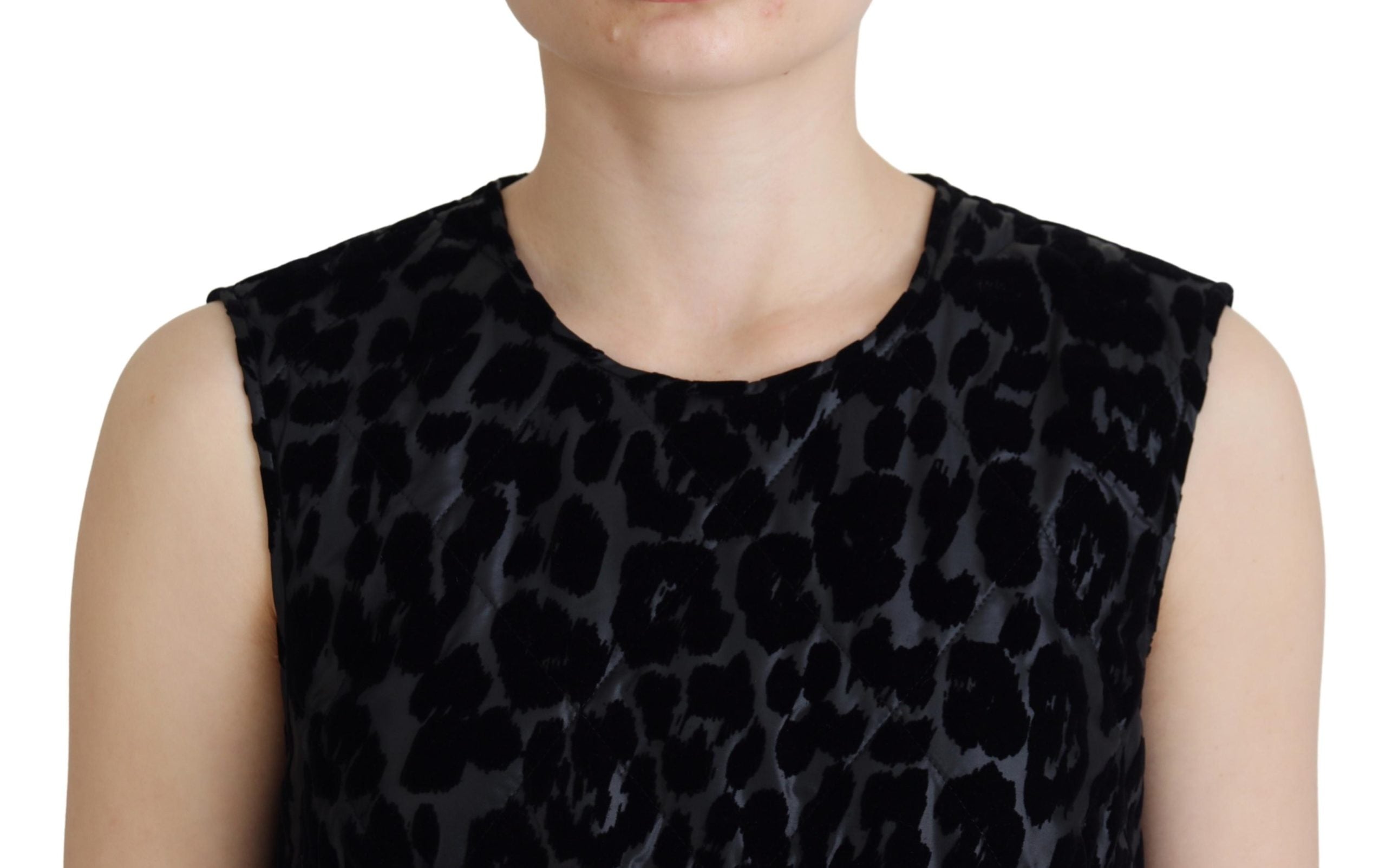 Black leopard print shift mini dress by Dolce & Gabbana, showing a fitted polyester dress with short sleeves and bold pattern.