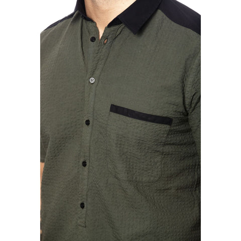 Jag Couture London green military-style jacket with structured design and front pockets, shown on a model.