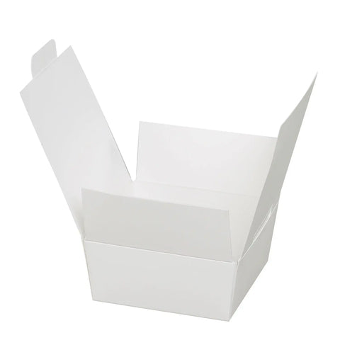 Four white chocolate ballotins from Jag Couture London New York, elegantly wrapped and displayed on a white background.