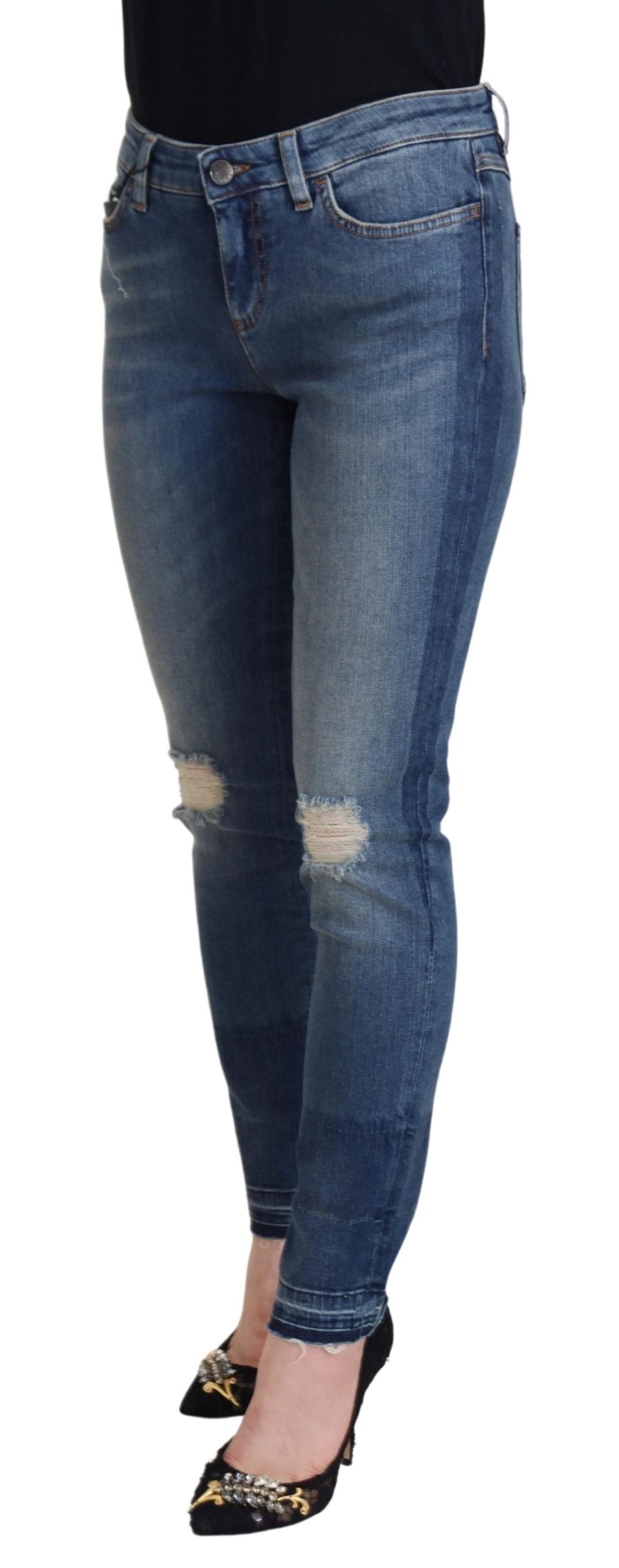 Blue washed cotton tattered denim jeans by Dolce & Gabbana with distressed details and classic five-pocket style.