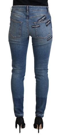 Blue washed cotton tattered denim jeans by Dolce & Gabbana, showing distressed details and classic fit.