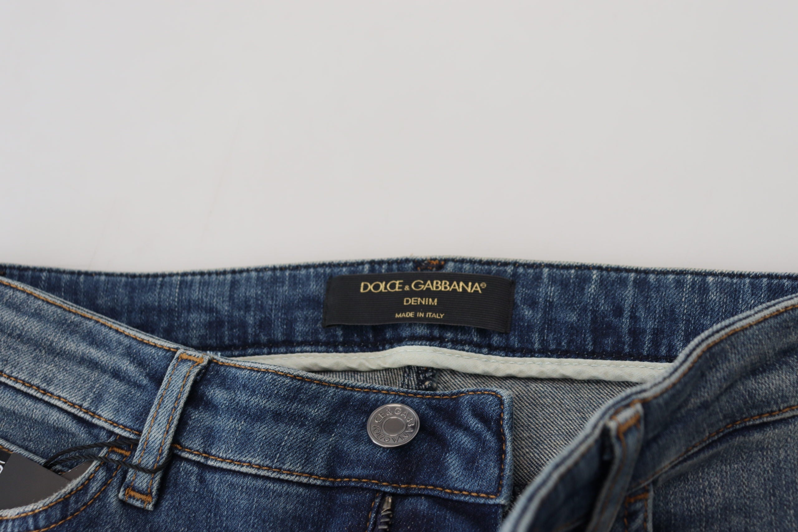 Blue washed cotton tattered denim jeans by Dolce & Gabbana, featuring distressed details and classic five-pocket design.