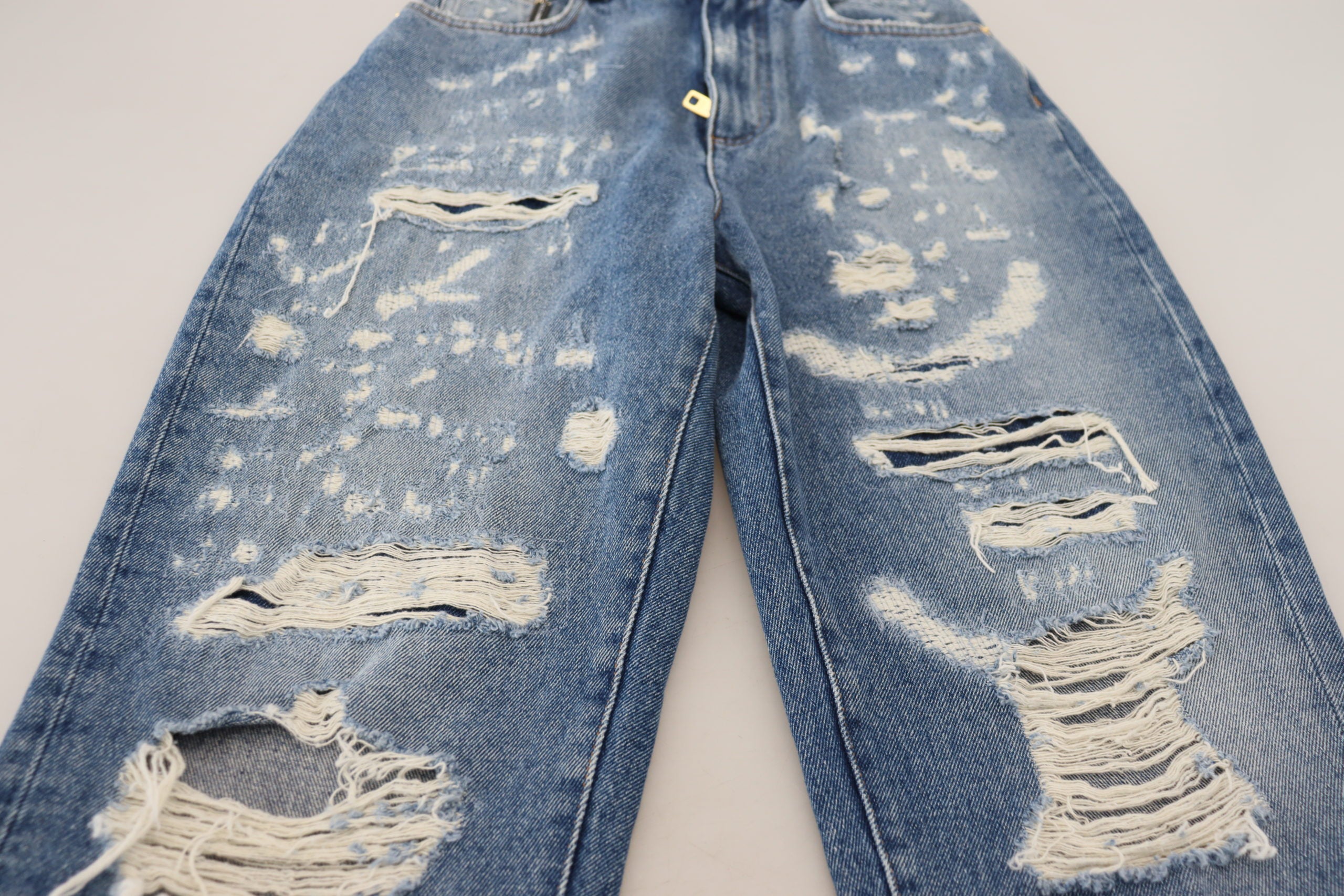 Blue washed cotton tattered denim jeans by Dolce & Gabbana displayed on a model.