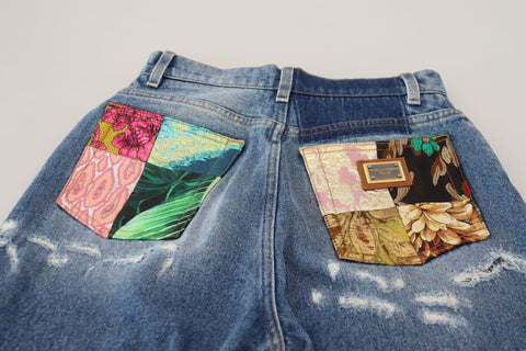 Blue washed cotton tattered denim jeans by Dolce & Gabbana, featuring distressed details and classic five-pocket design.