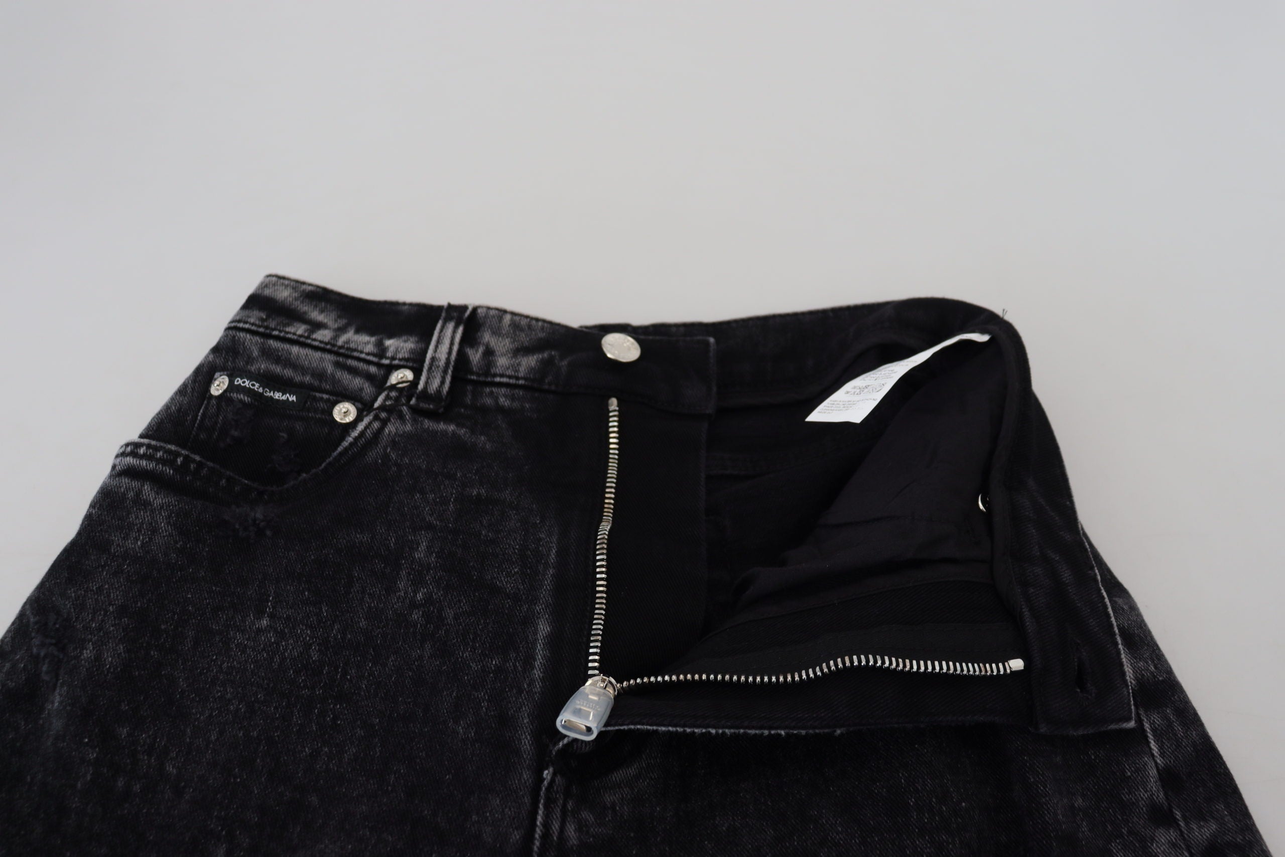 Black washed cotton high waist denim jeans by Dolce & Gabbana displayed on a hanger.