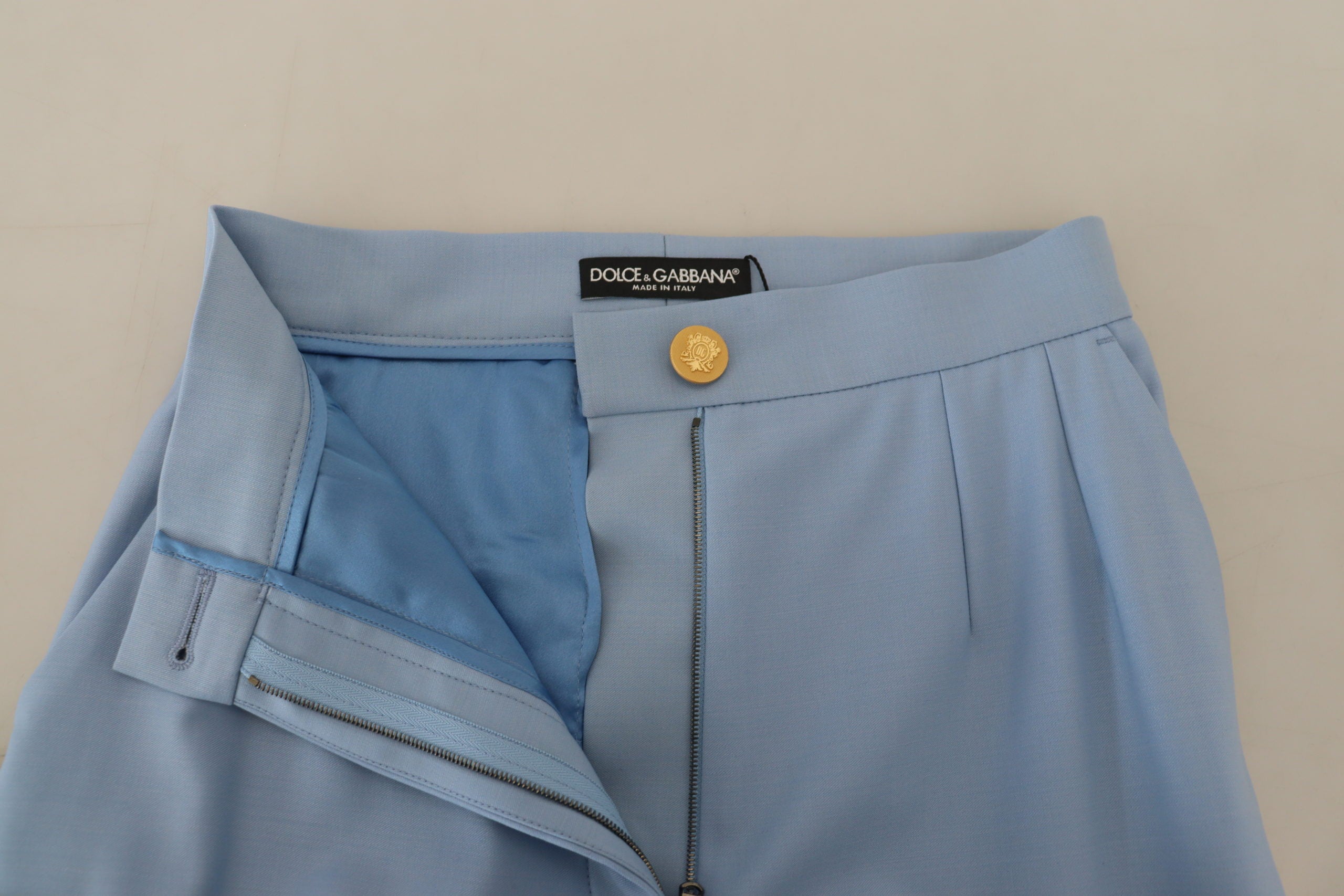 Light blue Dolce & Gabbana wide-leg pants with button details, featuring a relaxed fit and high-waisted design.