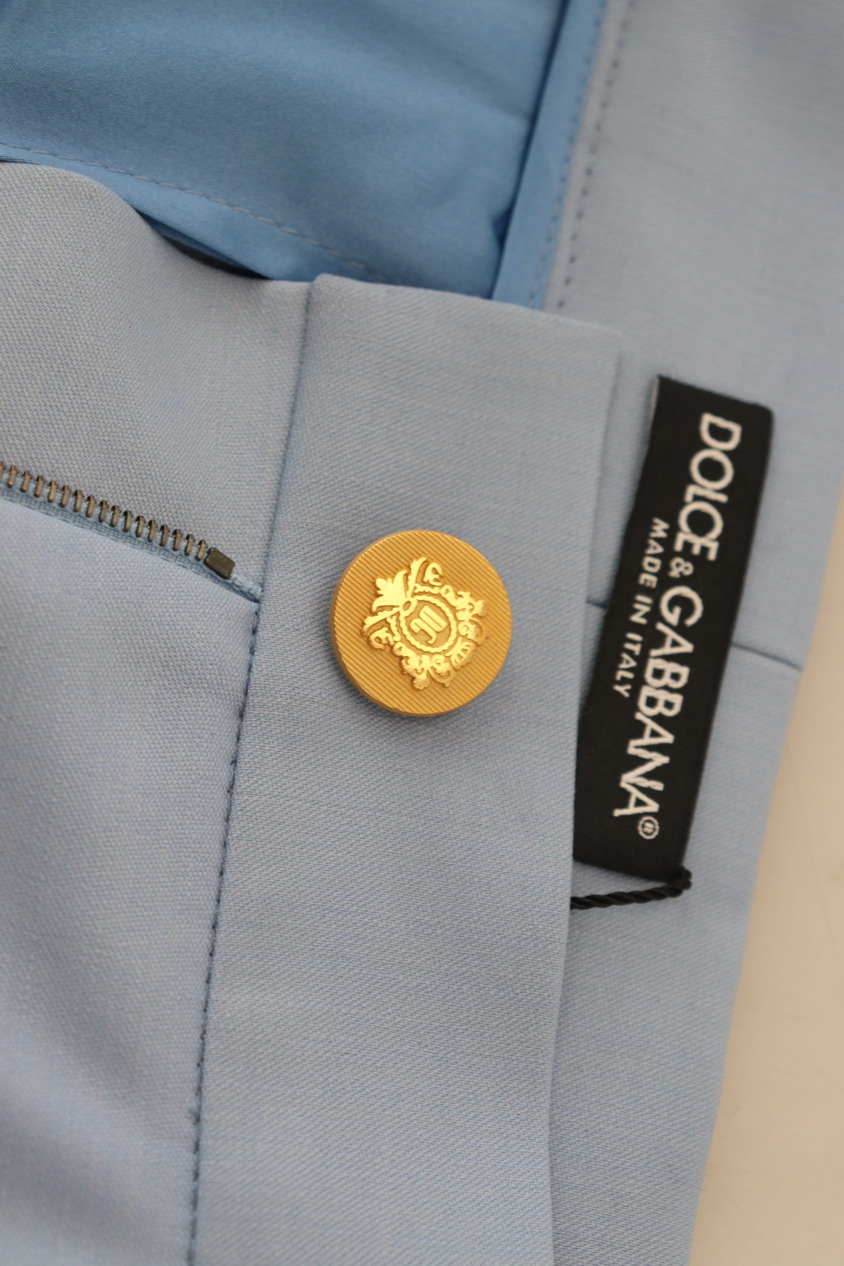 Light blue Dolce & Gabbana wide-leg pants with button details, featuring a relaxed fit and flowing fabric.