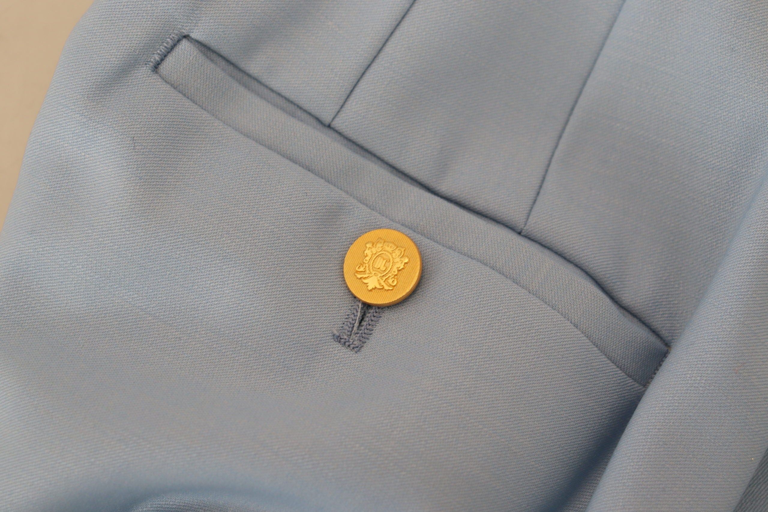 Light blue wide-leg pants by Dolce & Gabbana featuring button details and a relaxed fit.