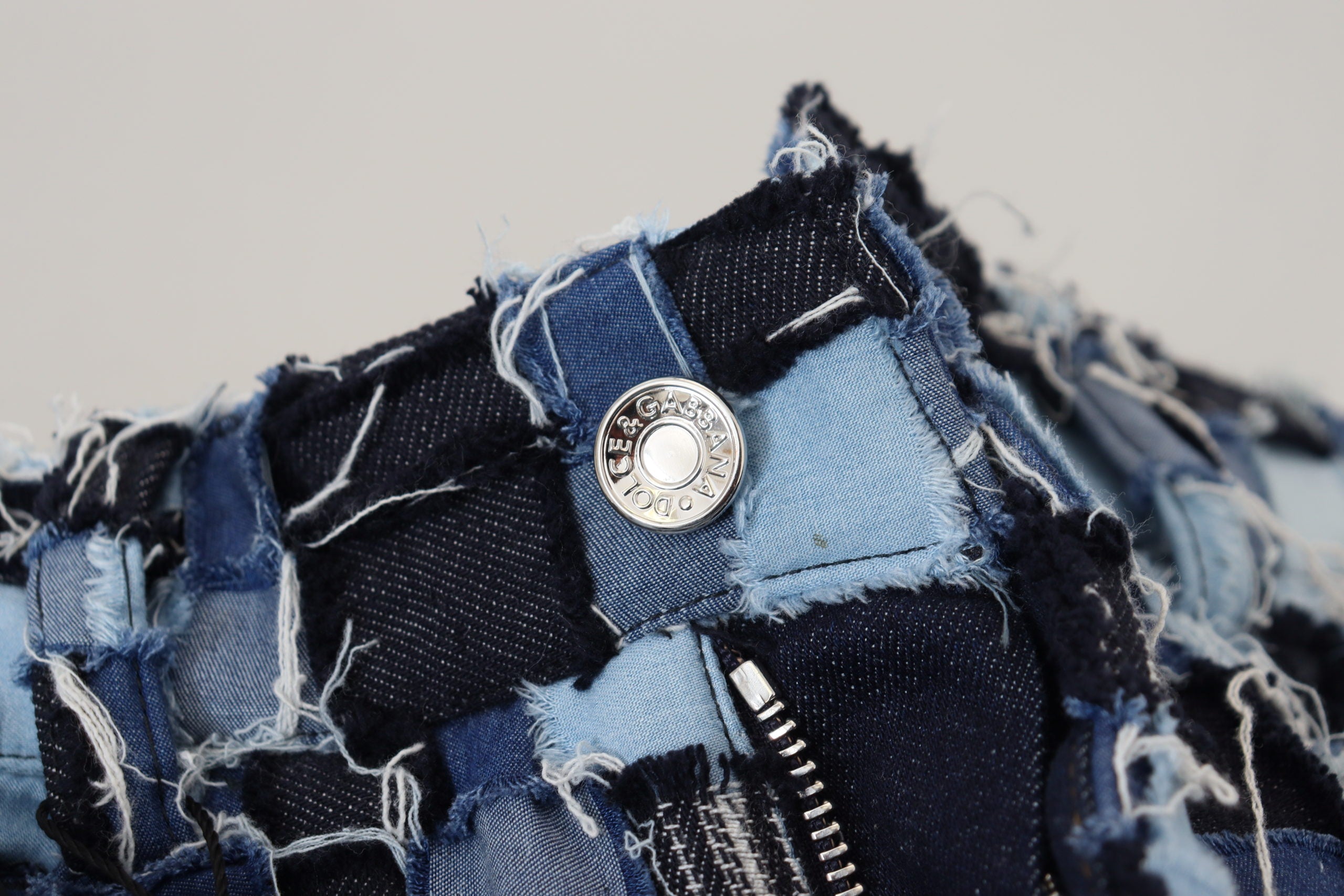 Multicolor patchwork cotton denim jeans by Dolce & Gabbana showing detailed stitching and vibrant fabric patterns.