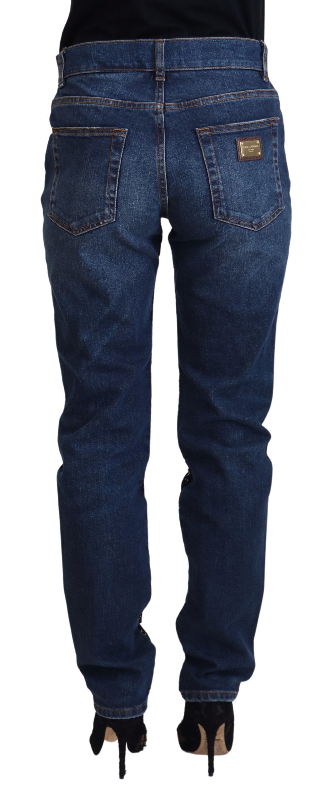 Black floral lace front skinny denim jeans by Dolce & Gabbana, featuring floral lace detail and a slim fit design.