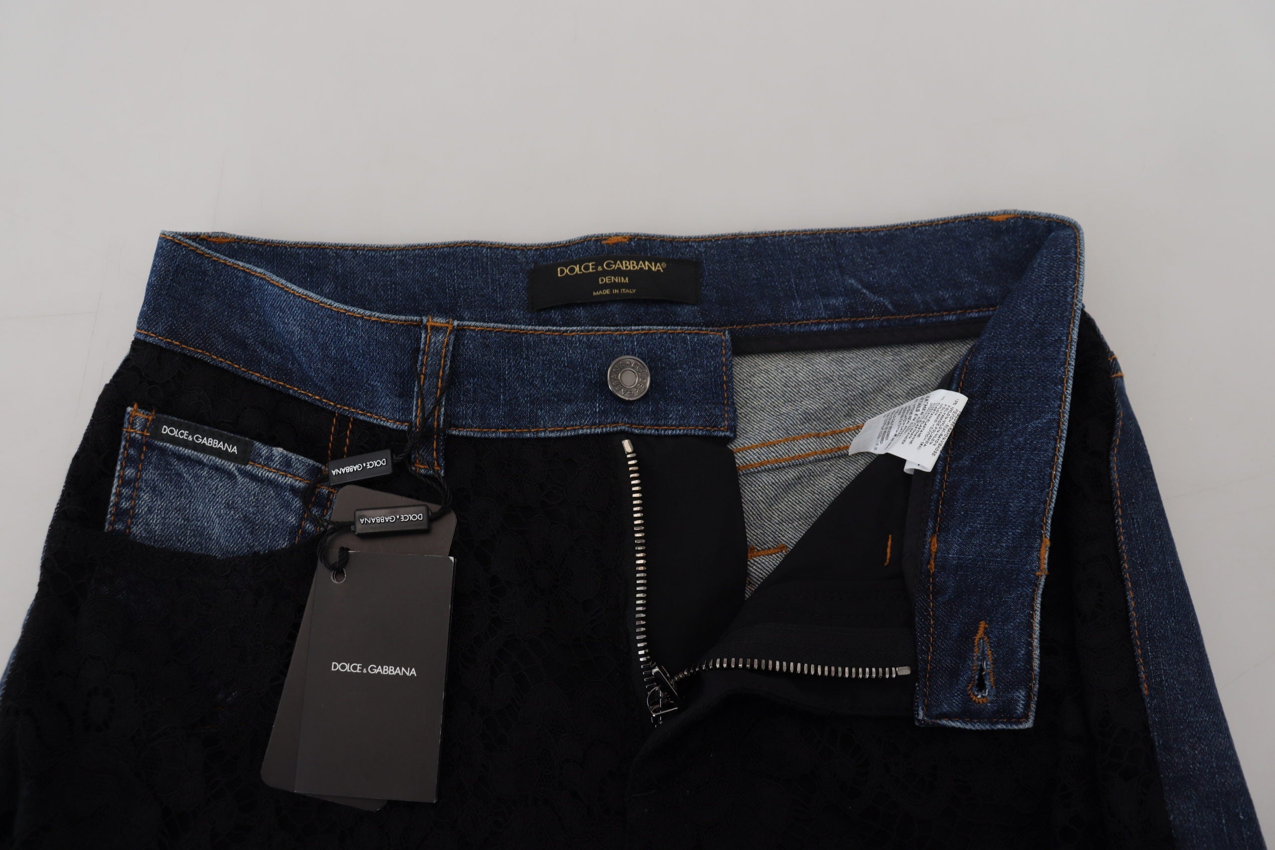 Black floral lace front skinny denim jeans by Dolce & Gabbana, featuring floral lace details and a fitted denim silhouette.