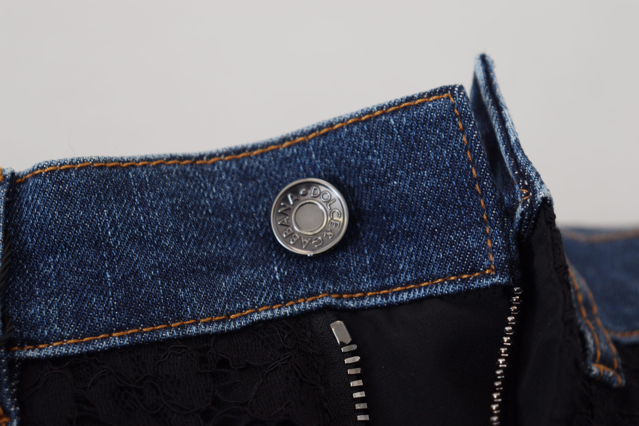 Black floral lace front skinny denim jeans by Dolce & Gabbana, showing floral lace details on the front and fitted denim style.