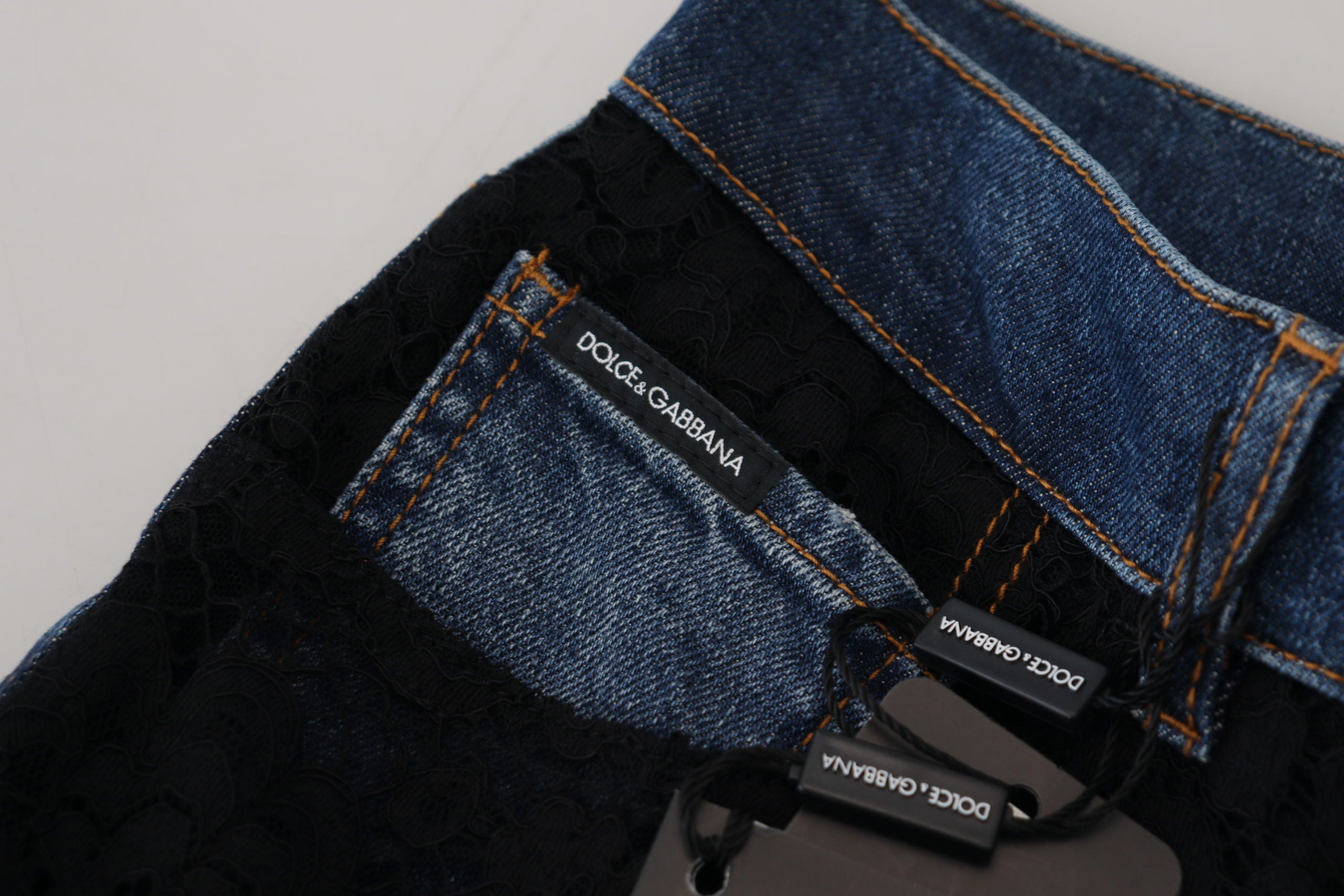 Black floral lace front skinny denim jeans by Dolce & Gabbana showing lace detail and fitted style.