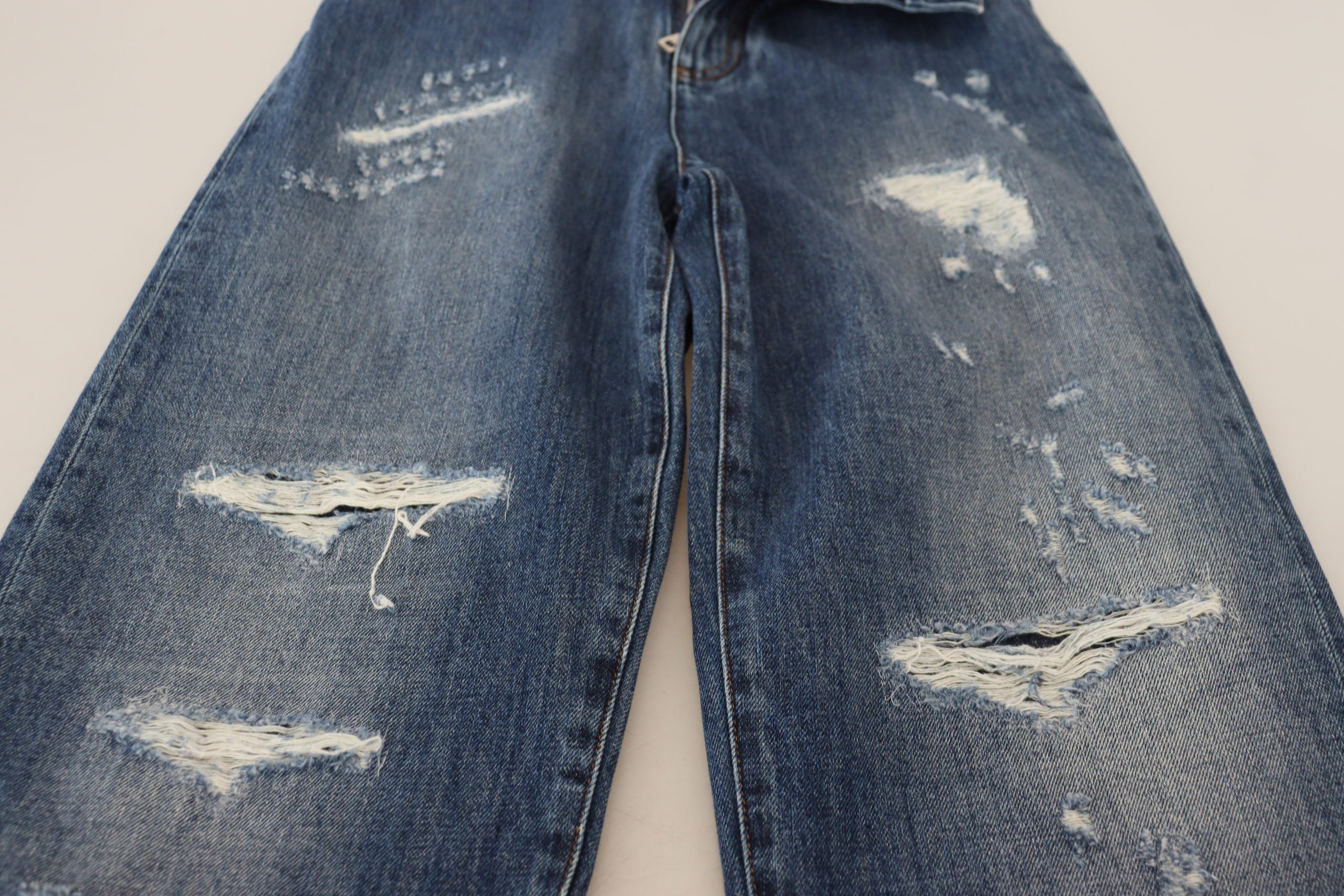 Blue washed cotton tattered denim jeans by Dolce & Gabbana with distressed details and a relaxed fit.