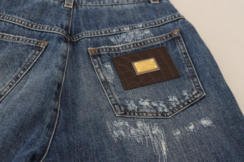 Blue washed cotton denim jeans with tattered details from Dolce & Gabbana, featuring a relaxed fit and distressed style.