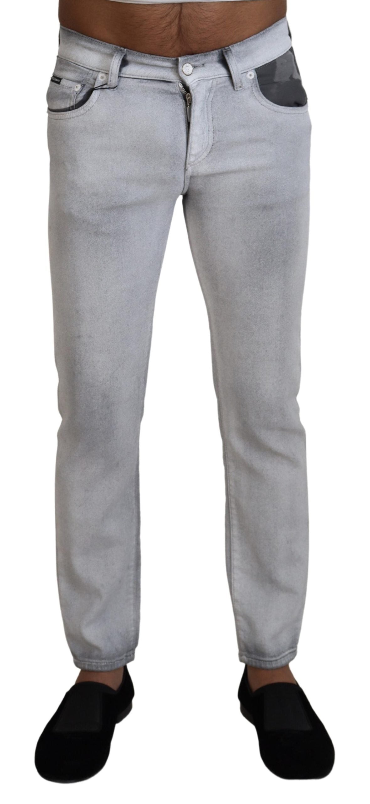 Gray washed skinny men's denim jeans by Dolce & Gabbana, close-up of fitted jeans with distressed details.