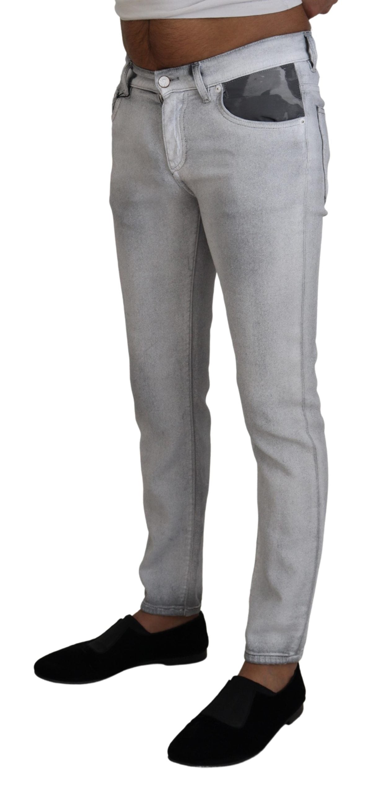 Gray washed skinny men's denim jeans by Dolce & Gabbana, showing close-up of distressed fabric and fitted style.
