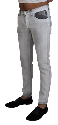 Gray washed skinny men's denim jeans by Dolce & Gabbana, showing close-up of distressed fabric and fitted style.