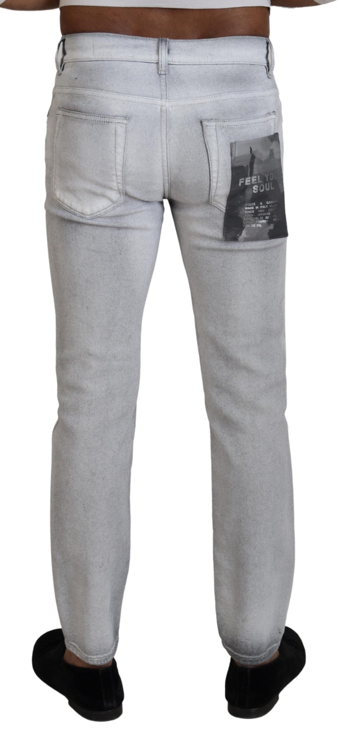 Gray washed skinny men's denim jeans by Dolce & Gabbana, showing close-up of fitted style and textured fabric details.