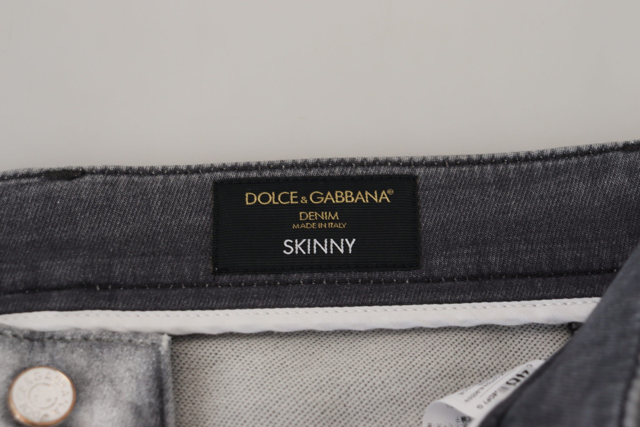 Gray washed skinny men's denim jeans by Dolce & Gabbana, showing fitted style with distressed details and classic five-pocket design.