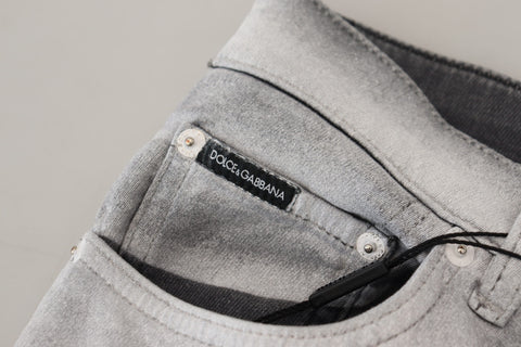 Gray washed skinny men's denim jeans by Dolce & Gabbana, showing fitted style with distressed details and classic five-pocket design.
